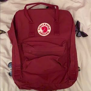 Wine colored Fjallraven Kanken 80” backpack.